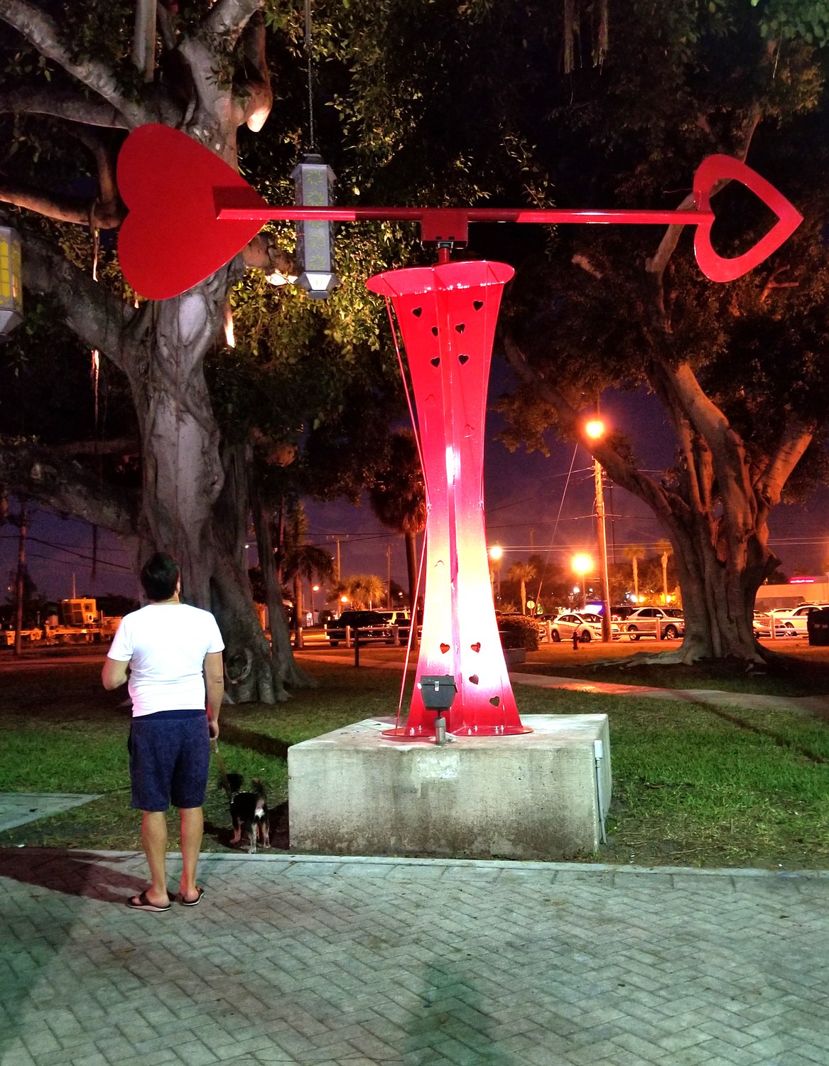 Let LOVE Guide Your Way red kinetic sculpture in a park